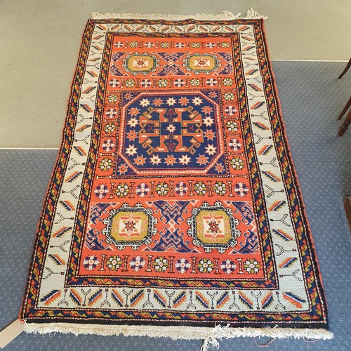 848 - A Kazak red ground rug, 216 x 134 cm