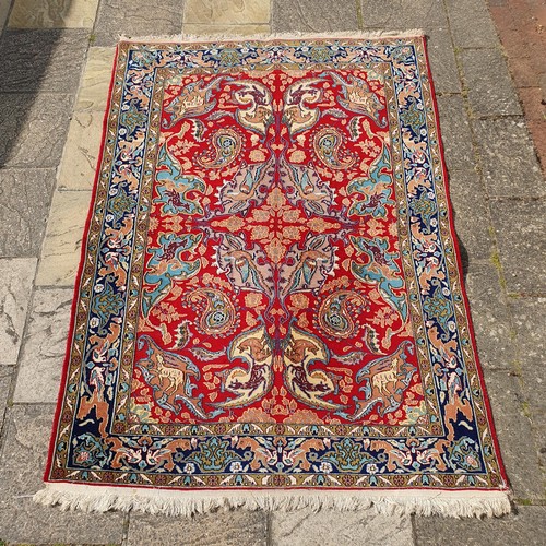 851 - A Persian Isfahan red ground rug, 215 x 153 cm