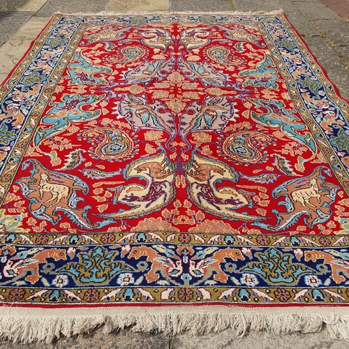 851 - A Persian Isfahan red ground rug, 215 x 153 cm