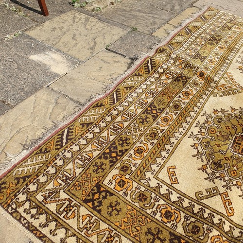 855 - An Afghan gold ground carpet, 285 x 202 cm