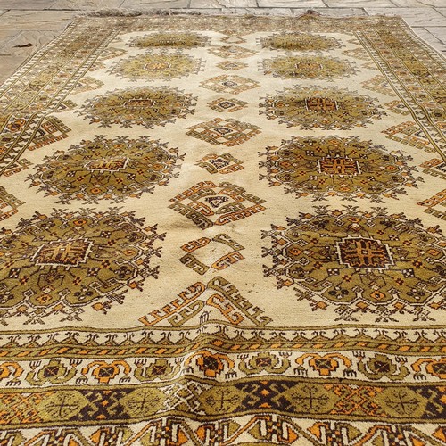 855 - An Afghan gold ground carpet, 285 x 202 cm