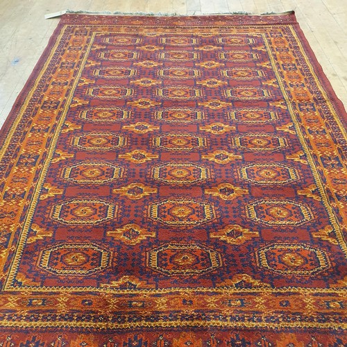 857 - An Afghan type red ground rug, 188 x 130 cm