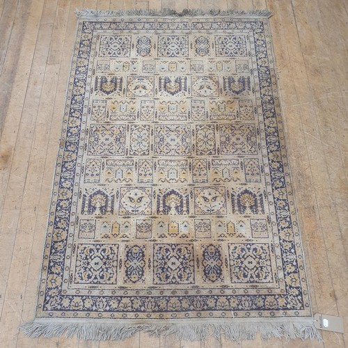 858 - A Persian type cream ground rug, centre with repeating square and rectangular medallions, 175 x 117 ... 