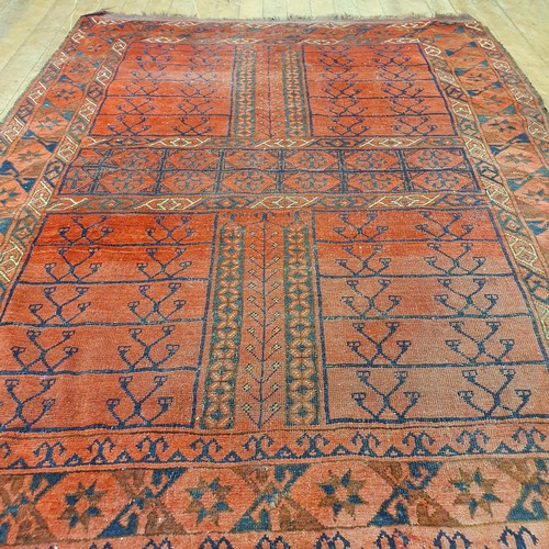 859 - A Persian type red ground rug, 185 x 137 cm