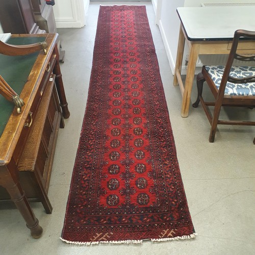 860 - An Afghan type red ground runner, 395 x 79 cm