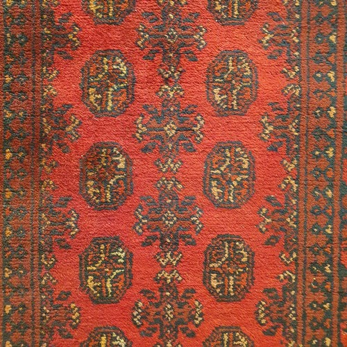 860 - An Afghan type red ground runner, 395 x 79 cm