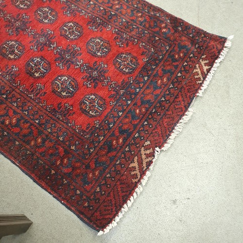 860 - An Afghan type red ground runner, 395 x 79 cm