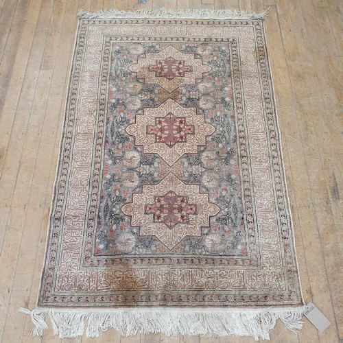 861 - A Persian type blue ground rug, the centre with three medallions, 178 x 118 cm