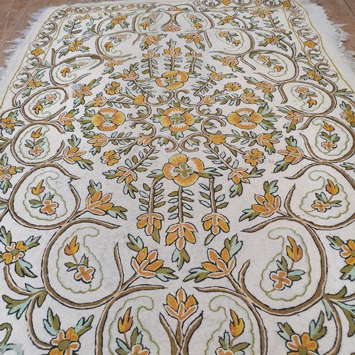 884 - A Namdha type rug, decorated house and garden, 120 x 195 cm, another, decorated floral forms, 178 x ... 