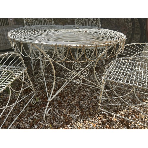 954 - A set of four wirework garden armchairs, and a table (5)