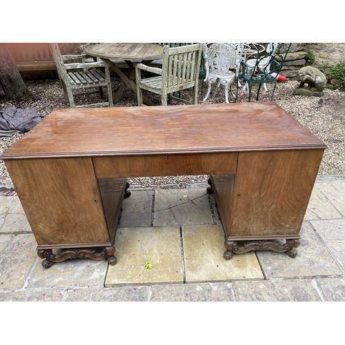 886 - A walnut kneehole desk, on squat cabriole legs, 158 cm wide