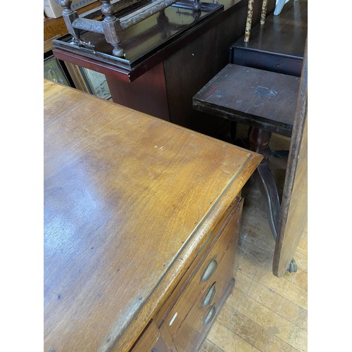 867 - A partners mahogany desk, the top having six drawers on pedestals, with three drawers flanked by a c... 