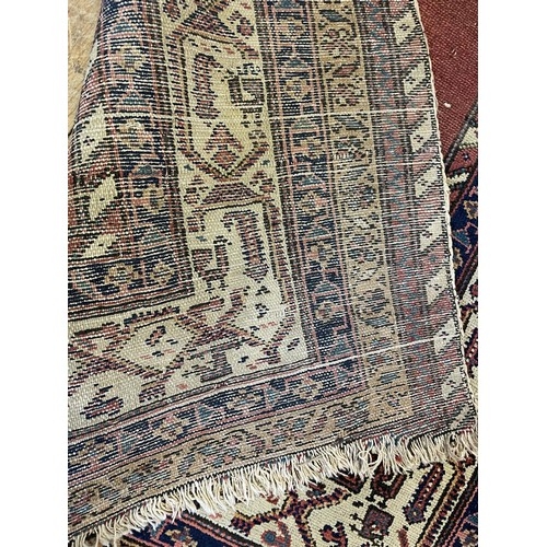 938 - A Persian red ground rug, with multiple borders, 180 x 98 cm