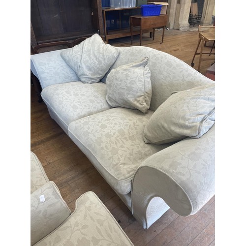 914 - A two seater sofa, with scrolled arms, 234 cm wide, three wingback armchairs, and an armchair (5)