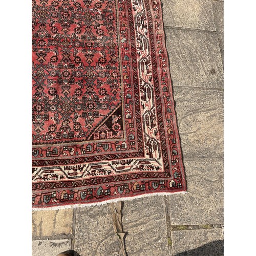 833 - A red ground Persian rug, 166 x 160 cm