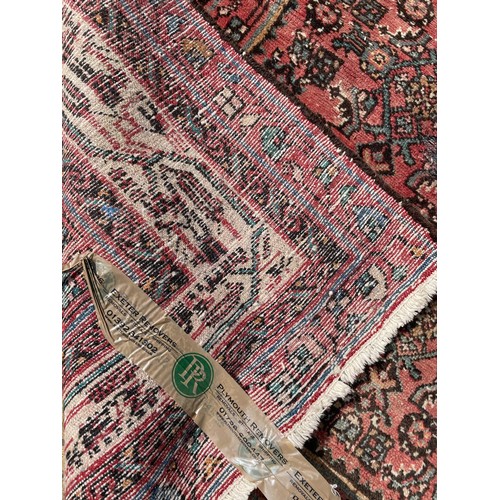 833 - A red ground Persian rug, 166 x 160 cm