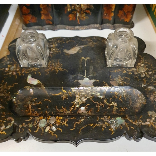 530 - A papier mache writing box, decorated flowers, 27 cm wide, an inkstand, 27 cm wide, lacking ink bott... 