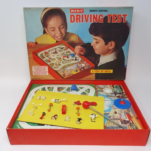 538 - A Chinese friction powered Standard Saloon convertible toy car, a Magic Robot game, and a driving te... 