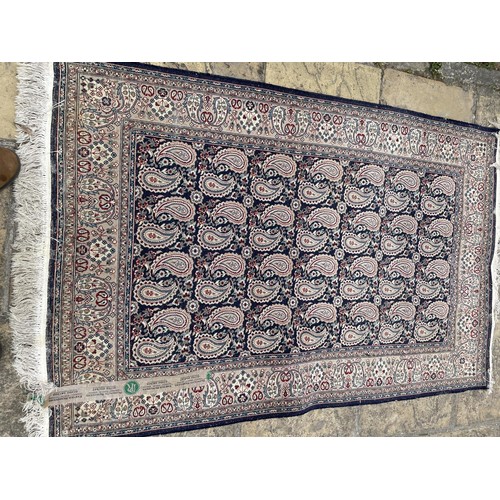 840 - A Persian blue ground rug, repeating teardrop medallion, 180 x 110 cm