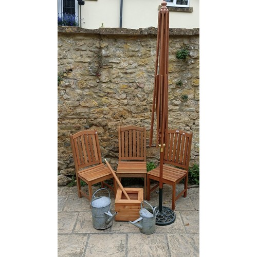 959 - A set of three teak garden chairs, a planter stand, a parasol, and two watering cans (7)