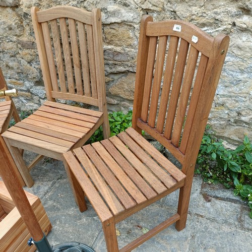 959 - A set of three teak garden chairs, a planter stand, a parasol, and two watering cans (7)