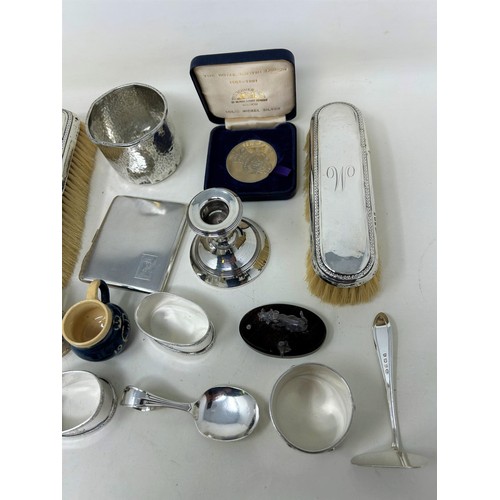 691 - A George V silver cigarette case, three napkin rings, a beaker, two miniature mugs, and assorted oth... 