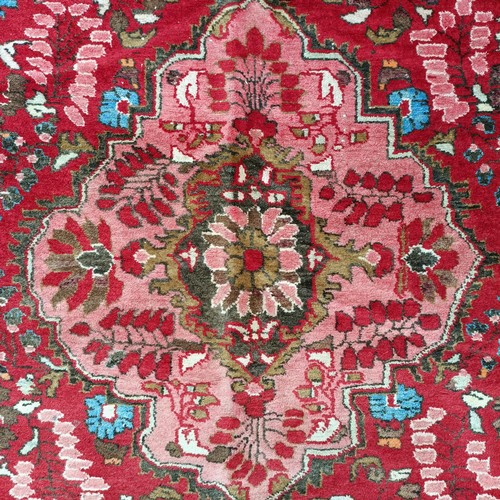 939 - A Persian red ground rug, 205 x 157 cm