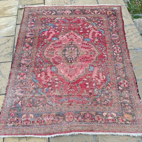 939 - A Persian red ground rug, 205 x 157 cm