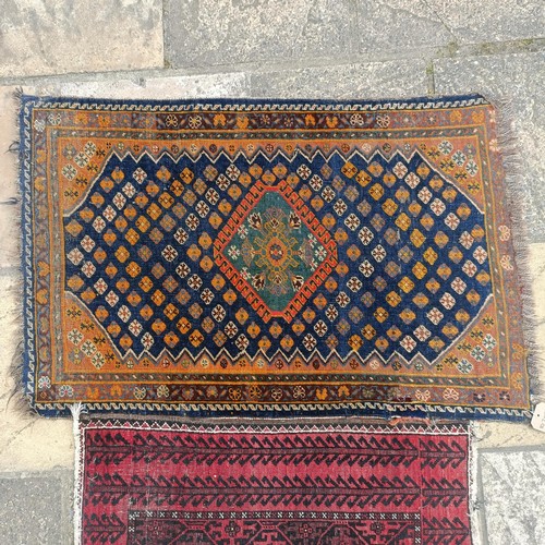 927 - A Persian blue ground rug, 107 x 76 cm, and a red ground rug, 86 x 76 cm (2)