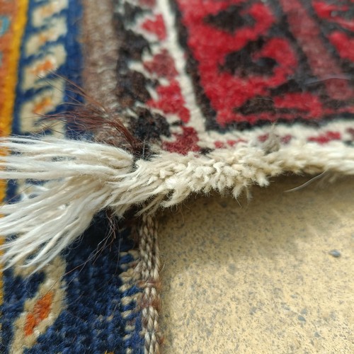 927 - A Persian blue ground rug, 107 x 76 cm, and a red ground rug, 86 x 76 cm (2)