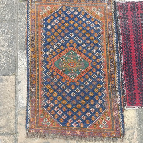 927 - A Persian blue ground rug, 107 x 76 cm, and a red ground rug, 86 x 76 cm (2)