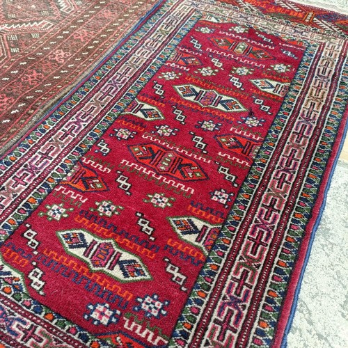 926 - A Persian red ground rug, 120 x 53 cm, a Persian red ground rug, 143 x 84 cm, and four other rugs (6... 