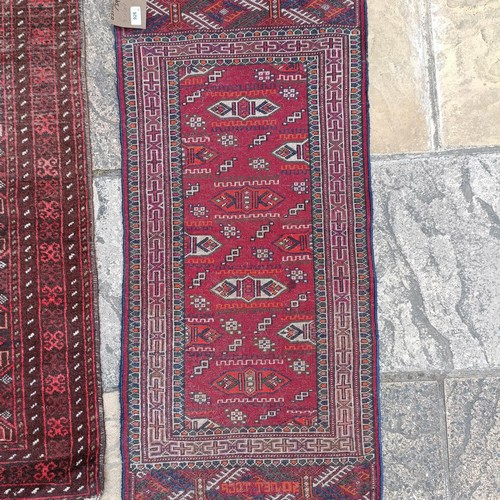 926 - A Persian red ground rug, 120 x 53 cm, a Persian red ground rug, 143 x 84 cm, and four other rugs (6... 