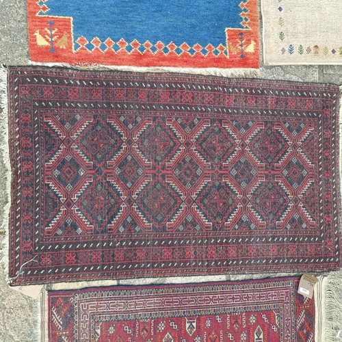 926 - A Persian red ground rug, 120 x 53 cm, a Persian red ground rug, 143 x 84 cm, and four other rugs (6... 