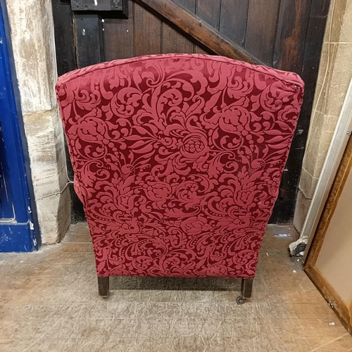 901 - A red upholstered armchair, and matching curtains