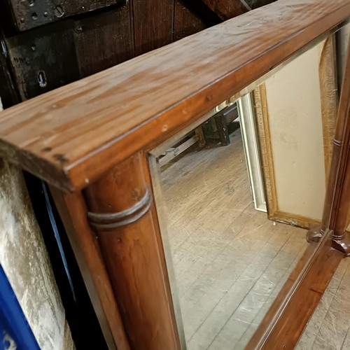 889 - A pine framed overmantel mirror, with column supports, 110 x 128 cm