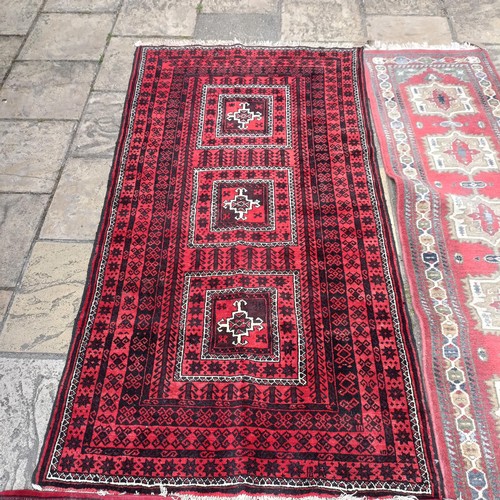 748 - A pink ground runner, 270 x 68 cm, a red ground rug, 137 x 80 cm, and another red ground rug, 214 x ... 