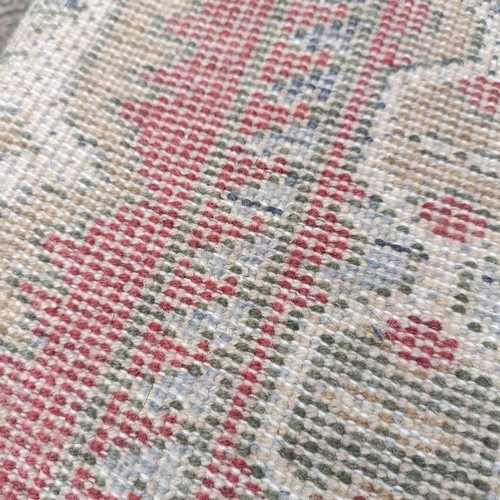 748 - A pink ground runner, 270 x 68 cm, a red ground rug, 137 x 80 cm, and another red ground rug, 214 x ... 