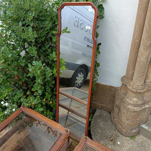 784 - A walnut framed wall mirror, 157 x 43 cm, and a pair of side tables (3)