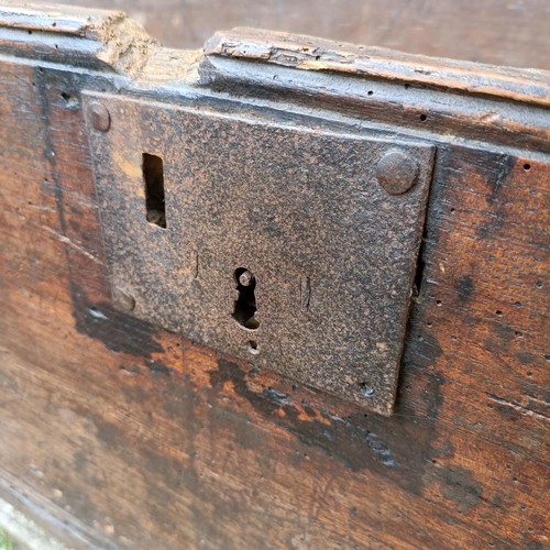 786 - An oak coffer of plank construction, in very poor order, 113 cm wide, a camphorwood and brass bound ... 