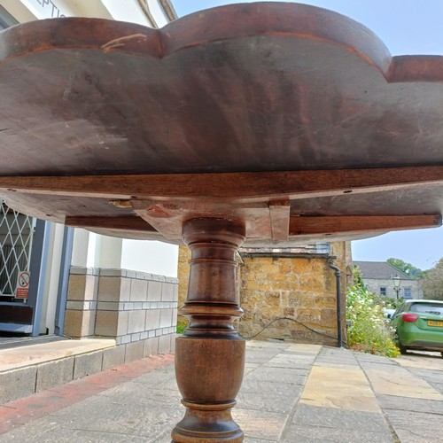 791 - A mahogany tripod table, with a shaped top, 84 cm diameter