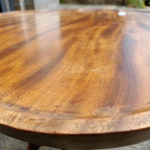 791 - A mahogany tripod table, with a shaped top, 84 cm diameter