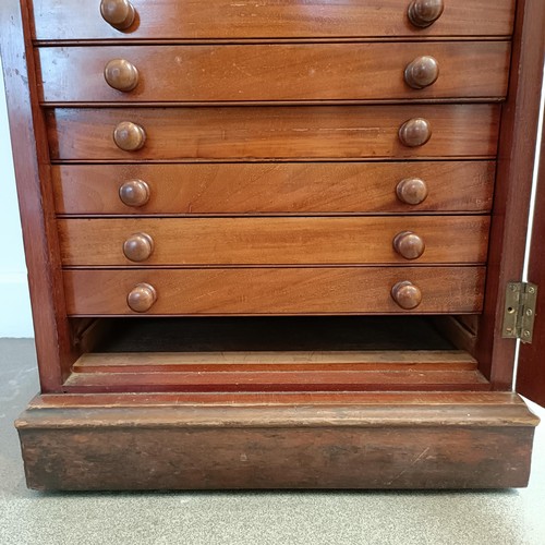 819 - A 19th century mahogany collectors cabinet, with a glazed door to reveal twenty drawers, one missing... 