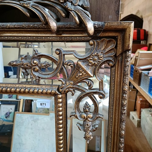 871 - A 19th century style gilt gesso rectangular mirror, with a shell finial, 180 x 92 cm