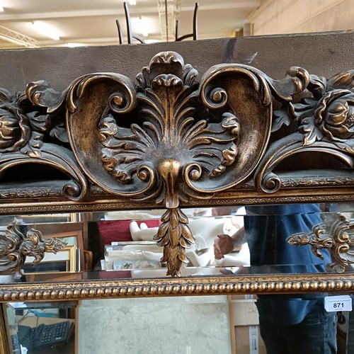 871 - A 19th century style gilt gesso rectangular mirror, with a shell finial, 180 x 92 cm