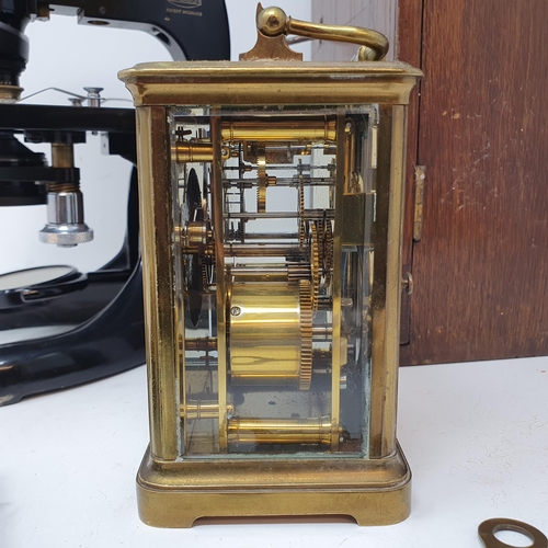 546 - A student's microscope, in an oak case, a carriage clock, a set of scales, and a sight (4)