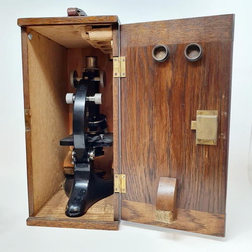 546 - A student's microscope, in an oak case, a carriage clock, a set of scales, and a sight (4)