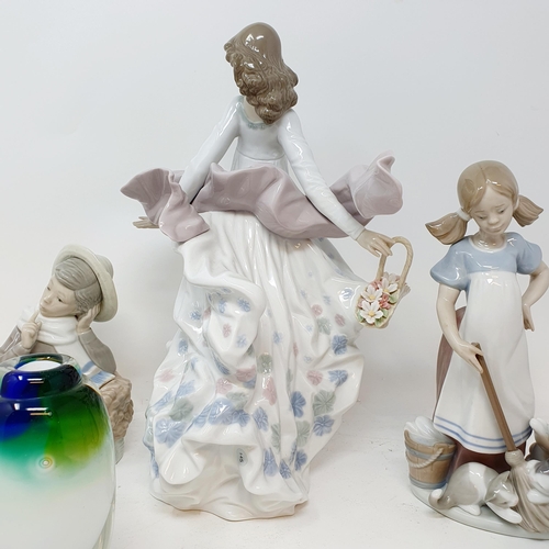 559 - A Lladro figure, girl with a basket, and three Caithness paperweights, and other figures (8)