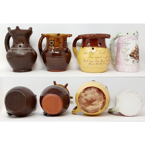 567 - A stoneware puzzle jug, with sprigged decoration, 22 cm high, and assorted other puzzle jugs (box)