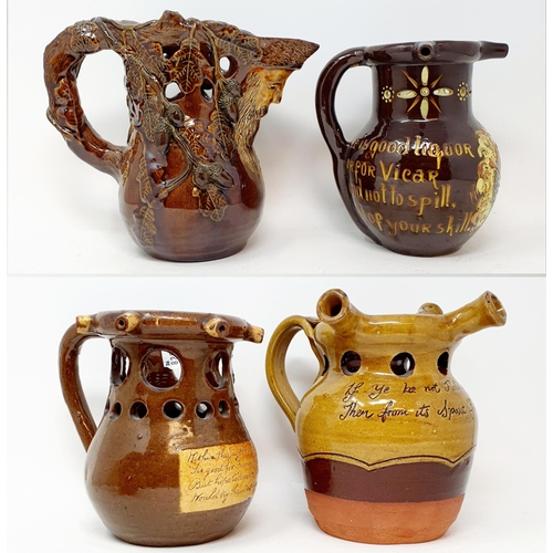 570 - A Brannam Pottery puzzle jug, 8 cm high, and three other puzzle jugs (4)